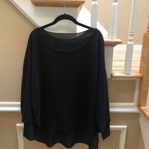 Black wool sweater with sheer black underlay.